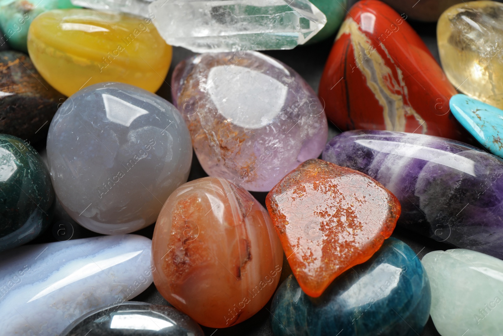 Photo of Different precious gemstones as background, closeup view