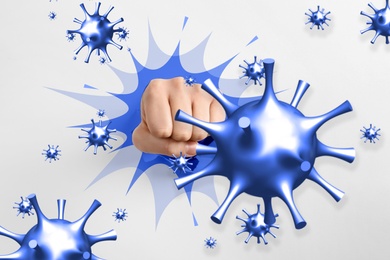 Image of Be healthy - boost your immunity to fight with illness. Woman showing clenched fist surrounded by viruses, closeup