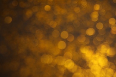 Photo of Blurred view of golden lights as background. Bokeh effect