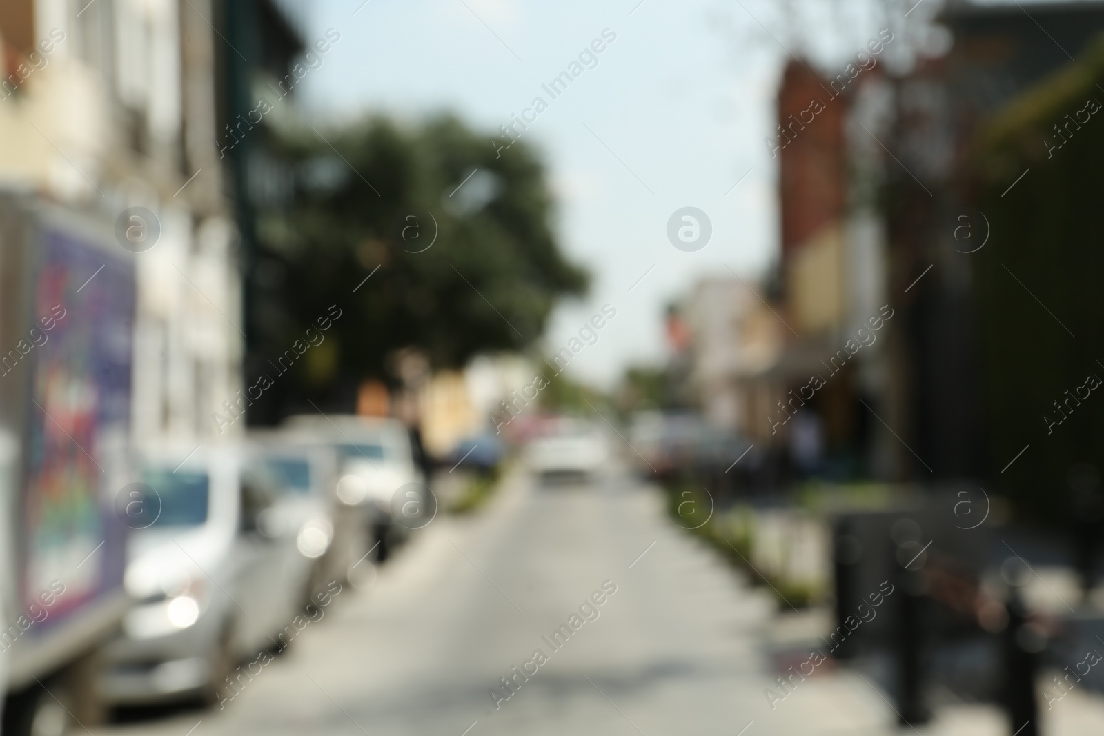 Photo of Blurred view of city street with cars