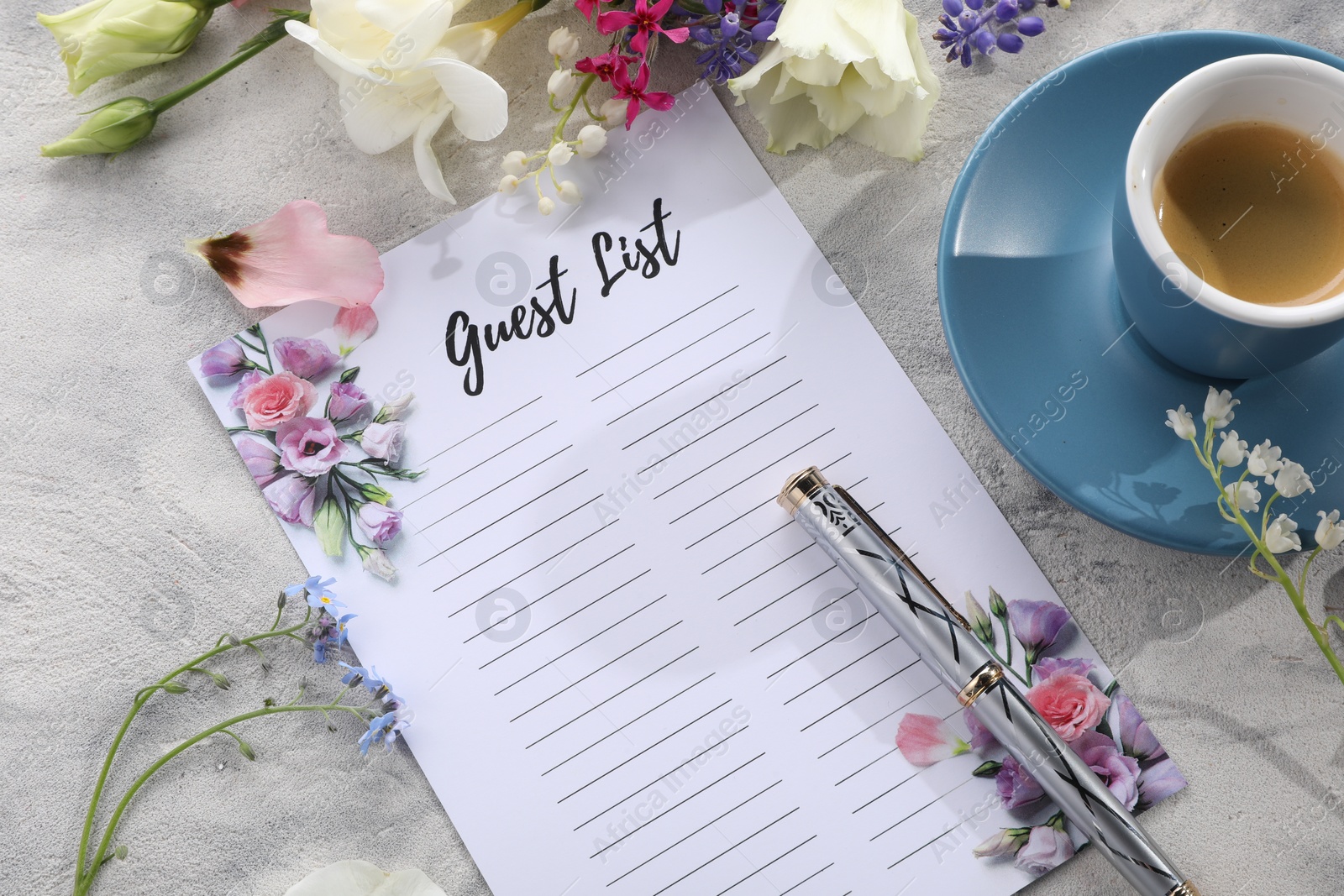 Photo of Guest list, coffee, pen and beautiful flowers on light textured table. Space for text