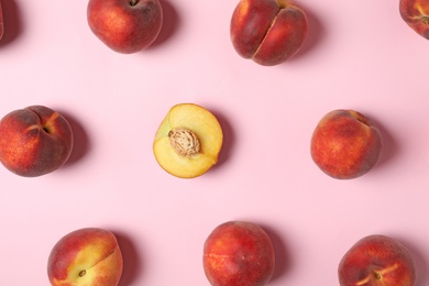 Flat lay composition with sweet juicy peaches on pink background