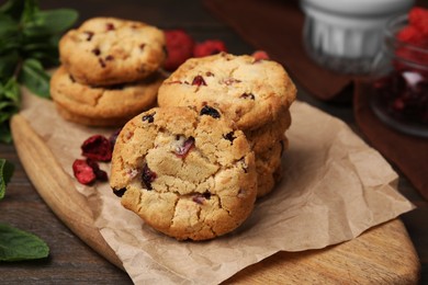 Photo of Cookies with freeze dried fruits and mint on wooden table, closeup