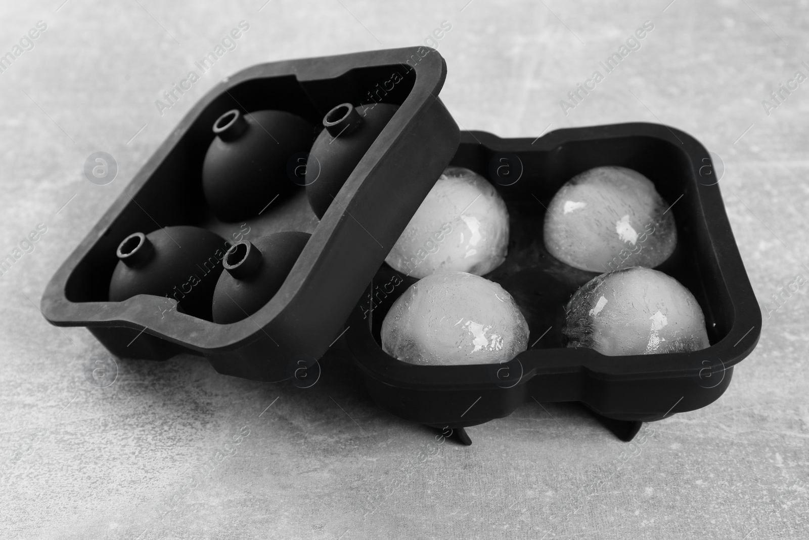 Photo of Frozen ice balls in mold on grey table