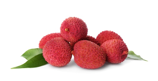 Pile of fresh ripe lychees with green leaves on white background