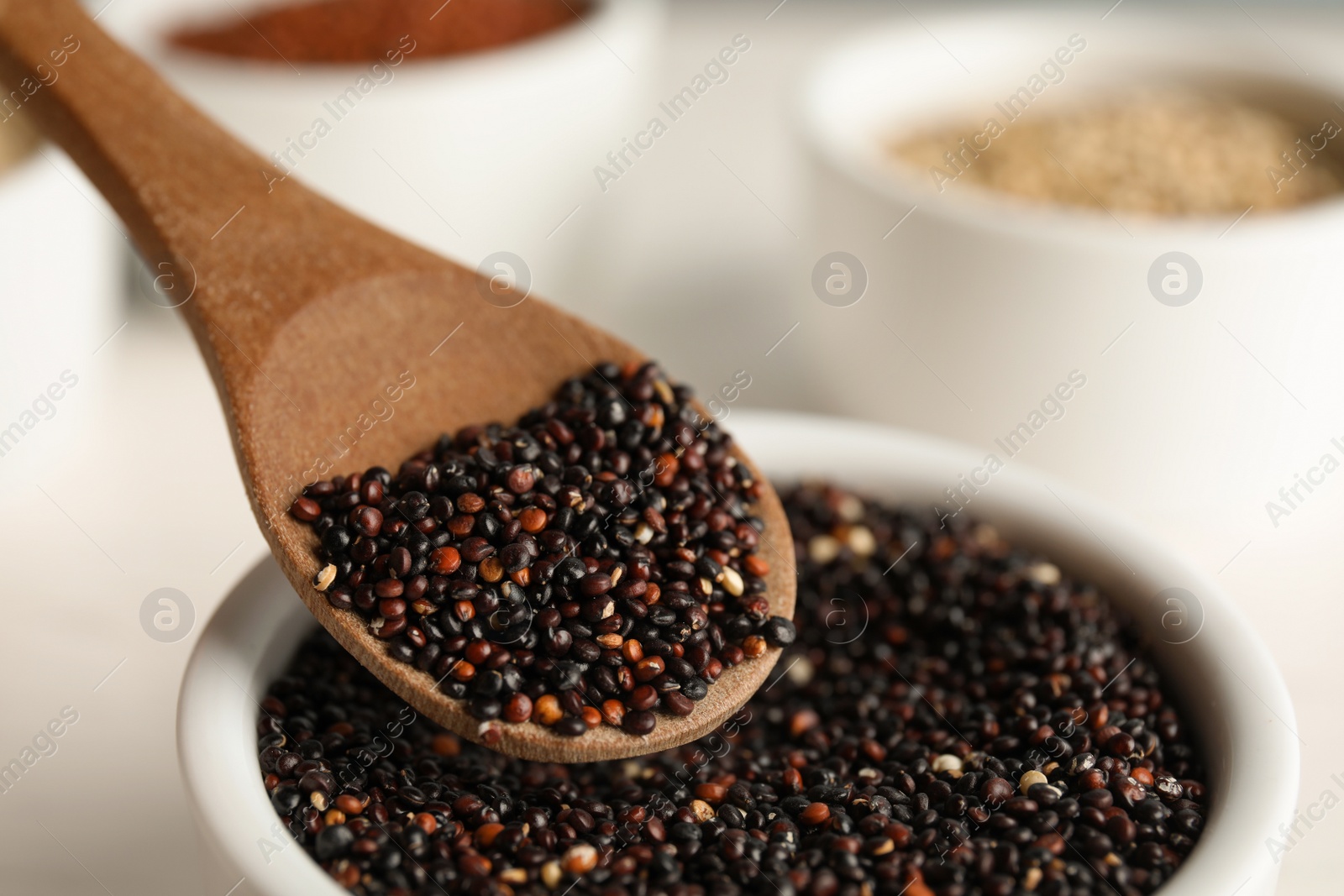 Photo of Spoon and bowl with black quinoa, closeup