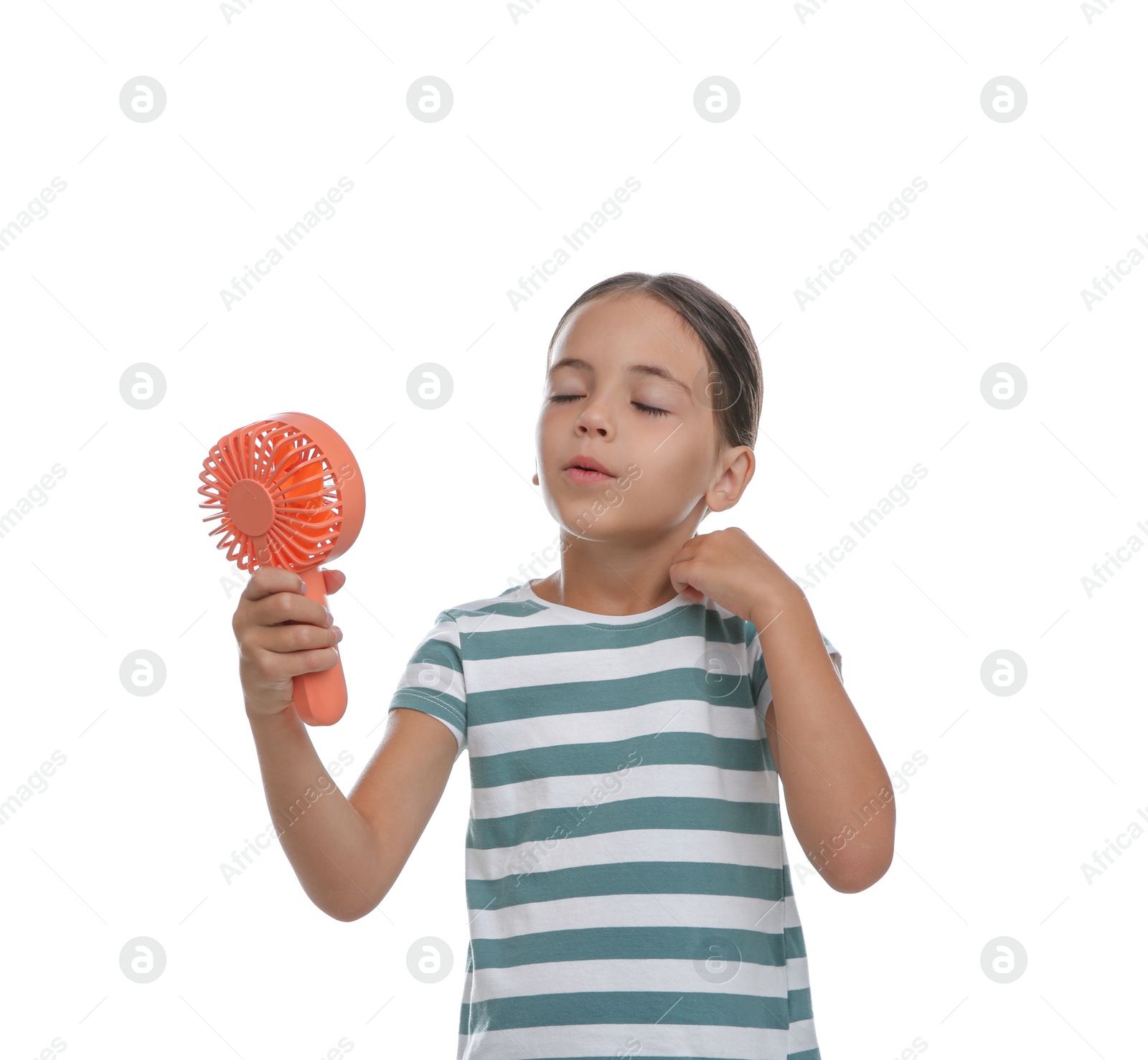 Photo of Little girl with portable fan suffering from heat on white background. Summer season