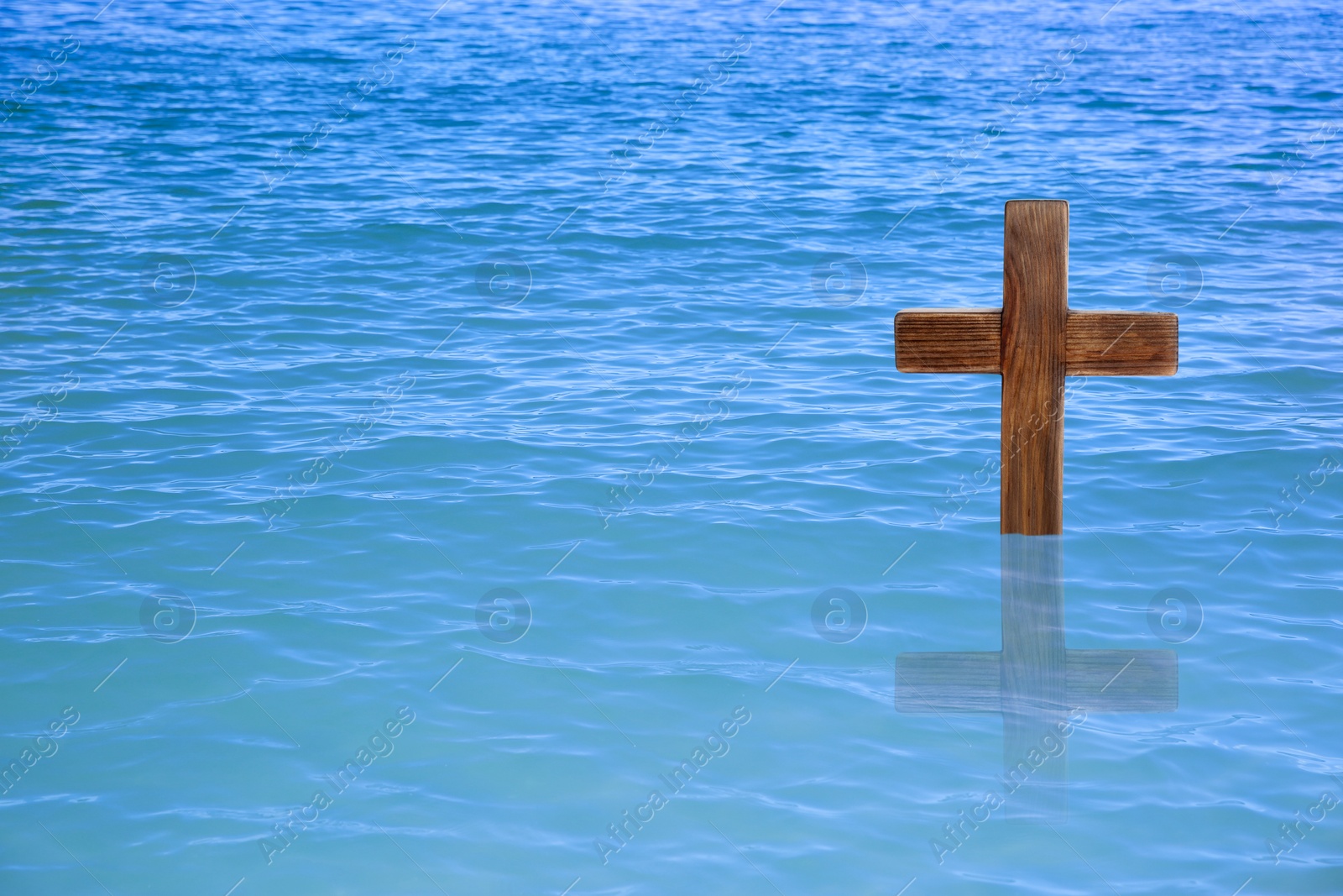 Image of Wooden cross in river for religious ritual known as baptism