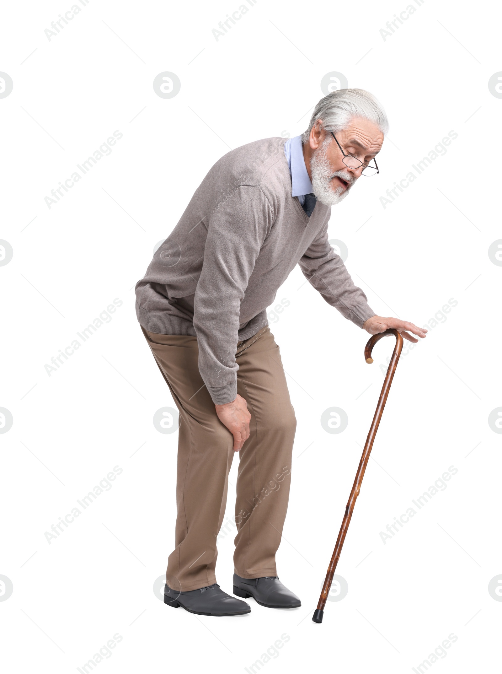 Photo of Senior man with walking cane suffering from knee pain on white background