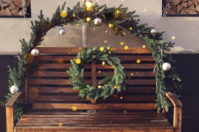 Photo of Beautiful Christmas wreath and decoration on wooden bench