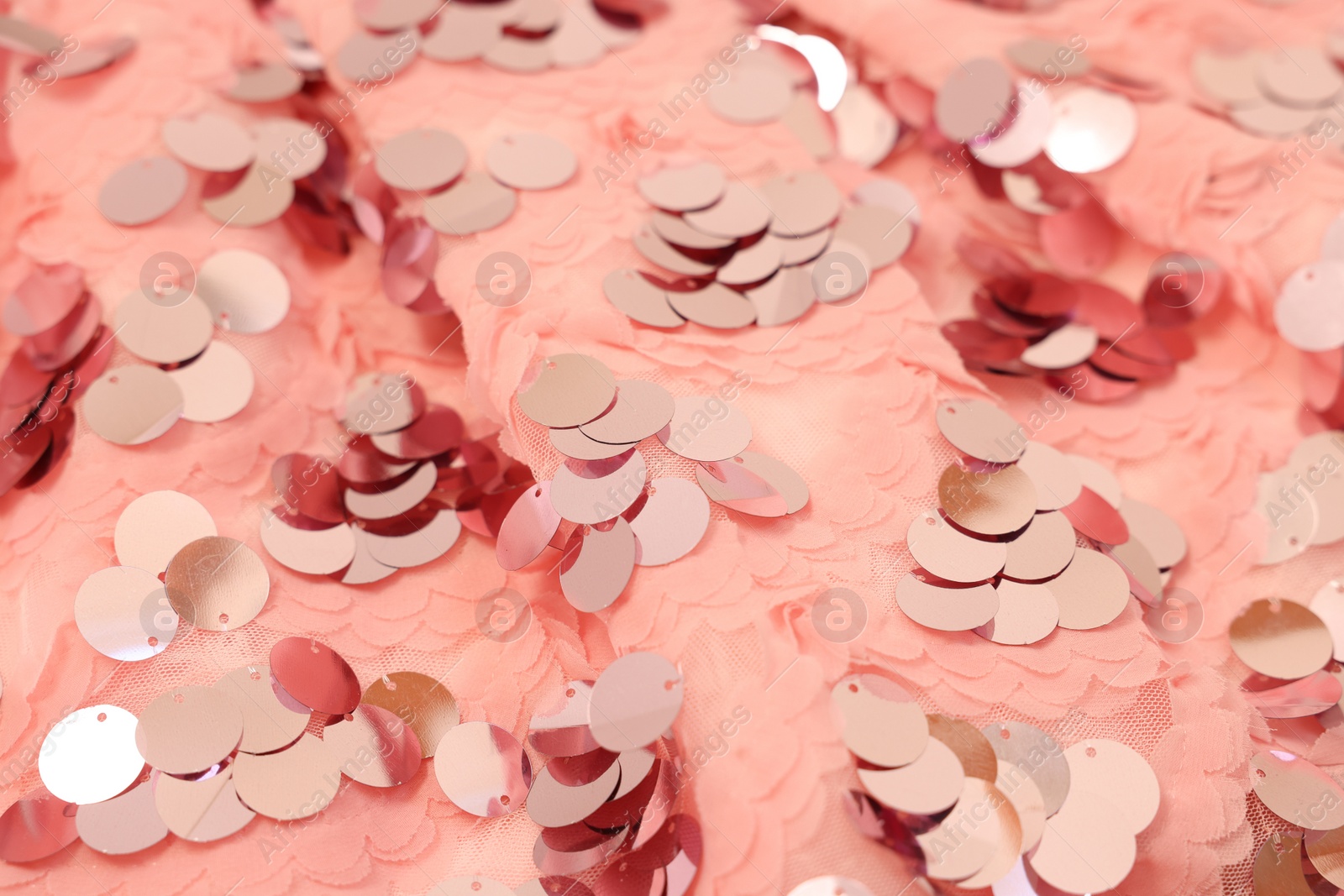 Photo of Texture of stylish pink carnival dress with sequins as background, closeup