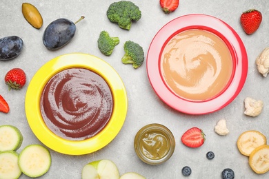 Photo of Healthy baby food and ingredients on grey table, flat lay