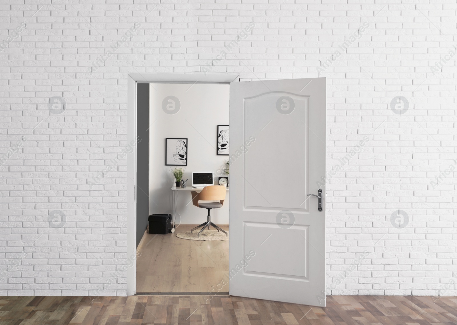 Photo of Stylish home office interior, view through open door