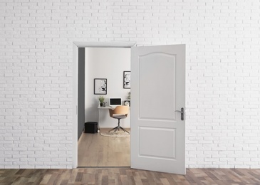 Photo of Stylish home office interior, view through open door