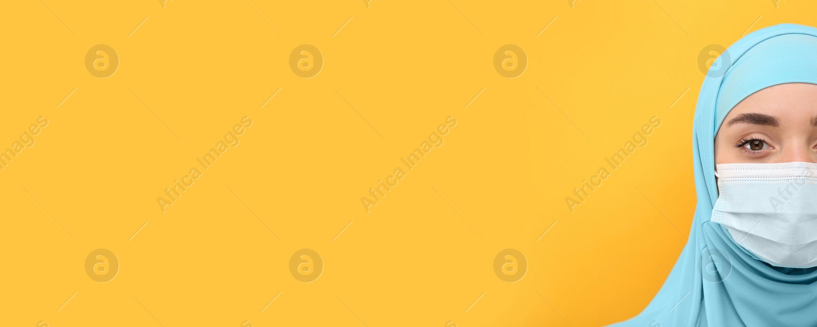 Image of Portrait of Muslim woman in hijab and medical mask on yellow background, space for text. Banner design