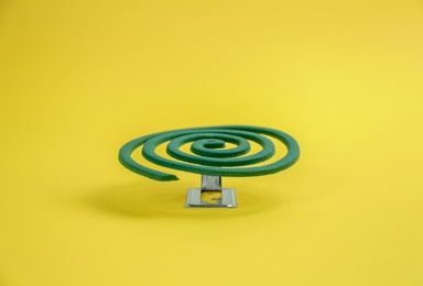 Photo of New insect repellent coil on yellow background