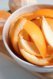 Photo of Orange zest preparing for drying and fresh fruits on white table, closeup