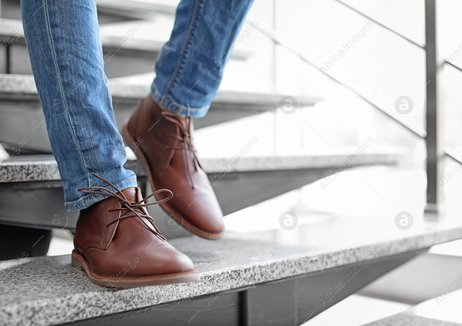 Photo of Man in in elegant shoes walking down stairs indoors