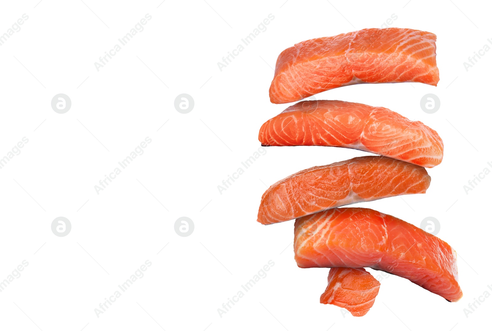 Image of Cut fresh salmon falling on white background