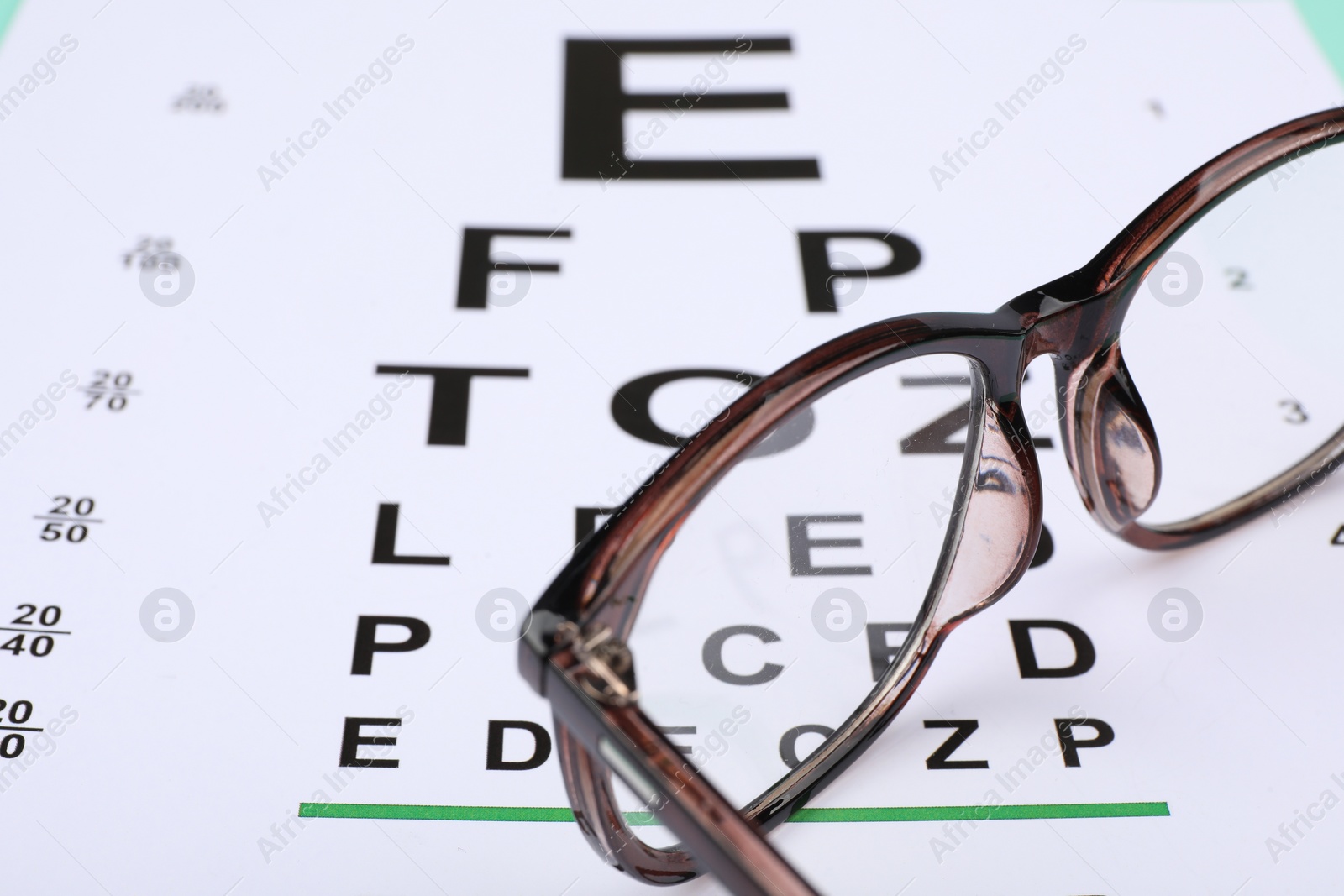 Photo of Vision test chart and glasses, closeup view