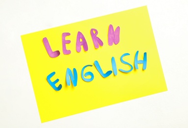 Photo of Note with phrase Learn English on white background, flat lay