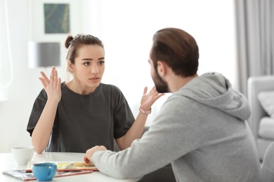 Photo of Young couple having argument at home