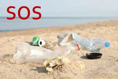 Image of Word SOS and garbage scattered on beach near sea. Recycling problem