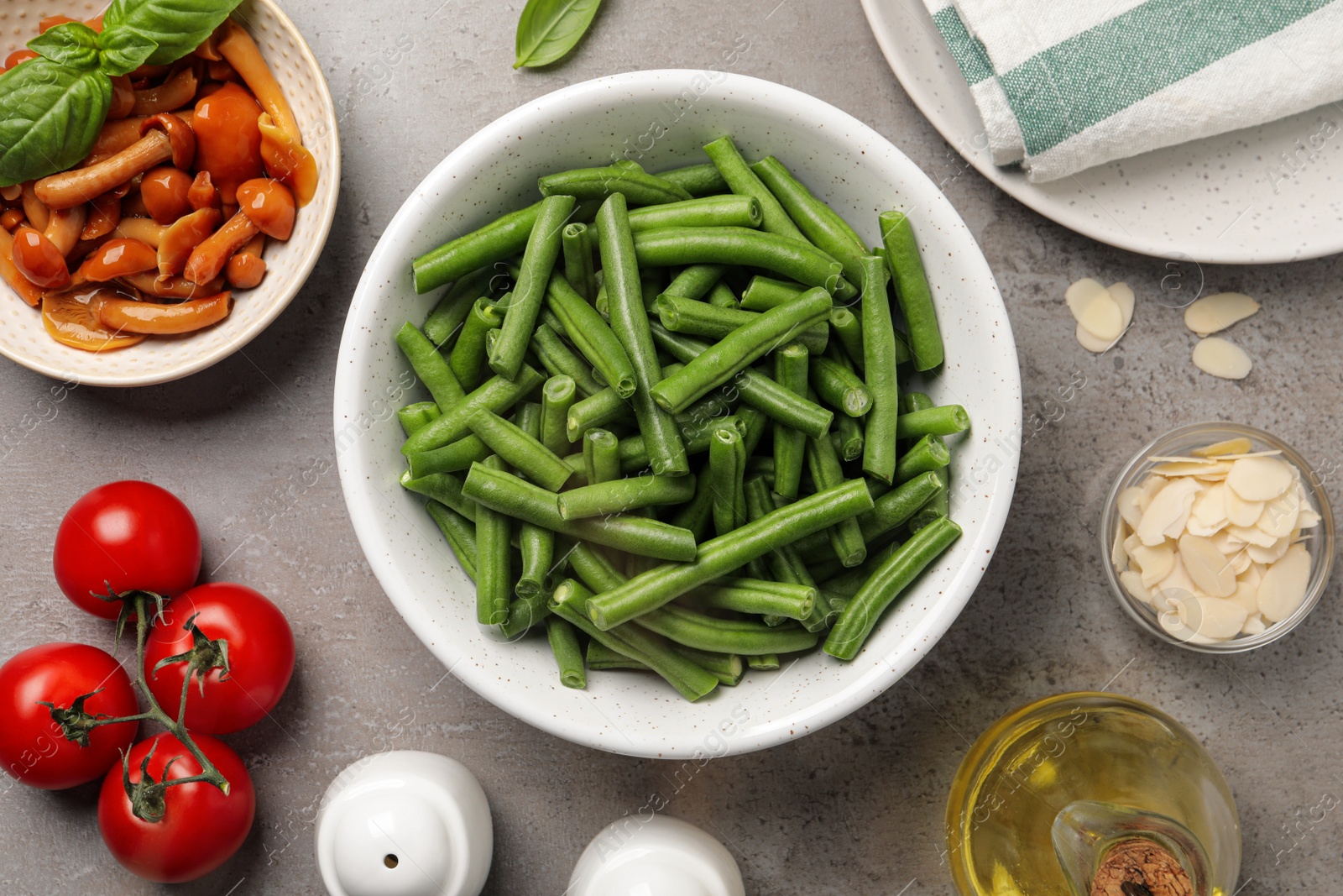 Photo of Fresh green beans and other ingredients for salad on grey table, flat lay