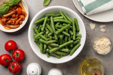 Fresh green beans and other ingredients for salad on grey table, flat lay