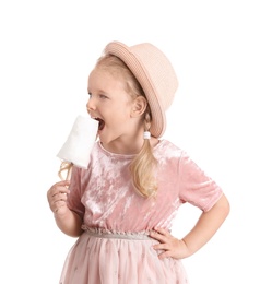 Photo of Cute little girl with cotton candy on white background