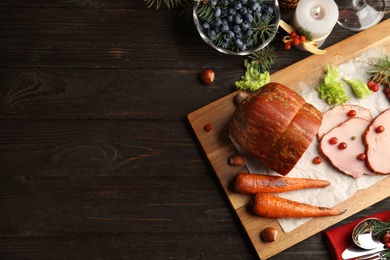 Photo of Flat lay composition with delicious ham on black wooden table, space for text. Christmas dinner