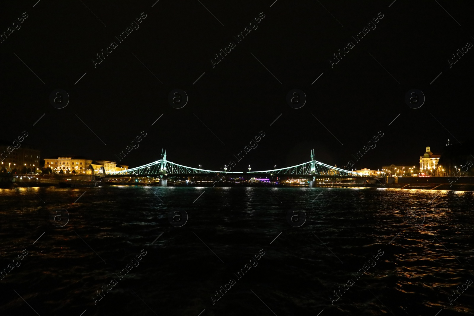 Photo of BUDAPEST, HUNGARY - APRIL 27, 2019: Beautiful night cityscape with illuminated Liberty Bridge across Danube river