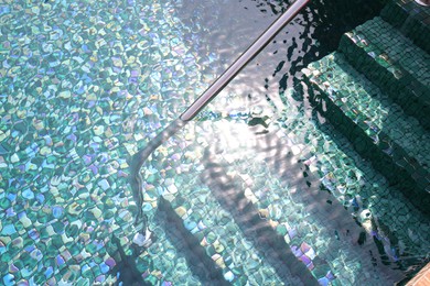 Photo of Outdoor swimming pool with steps and rail at resort