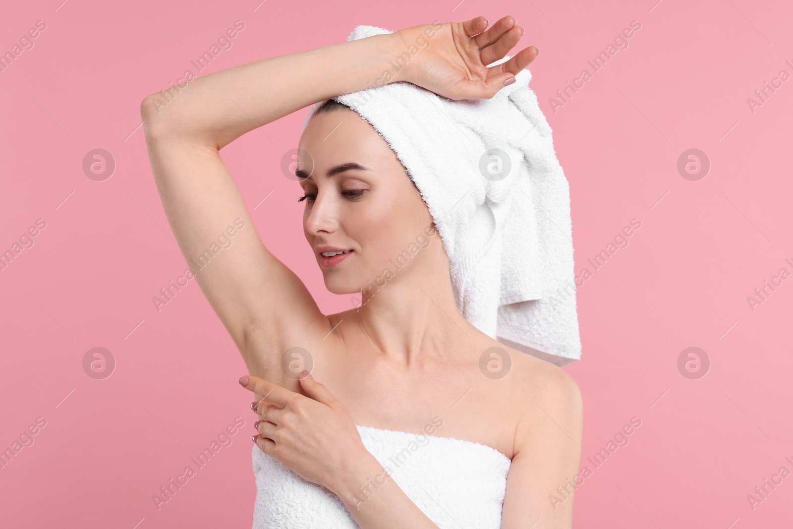 Photo of Beautiful woman showing armpit with smooth clean skin on pink background