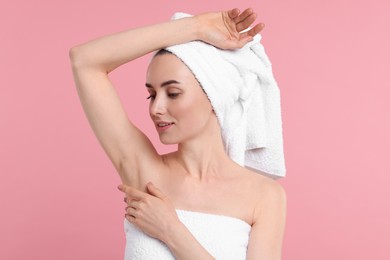 Photo of Beautiful woman showing armpit with smooth clean skin on pink background