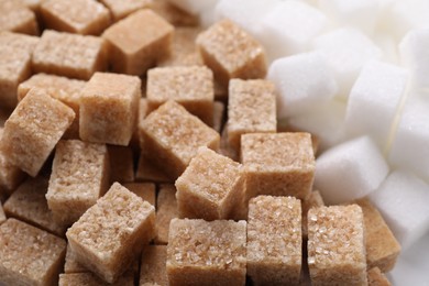 White and brown sugar cubes as background, closeup