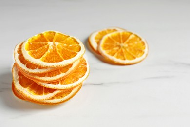 Photo of Dry orange slices on white table, space for text