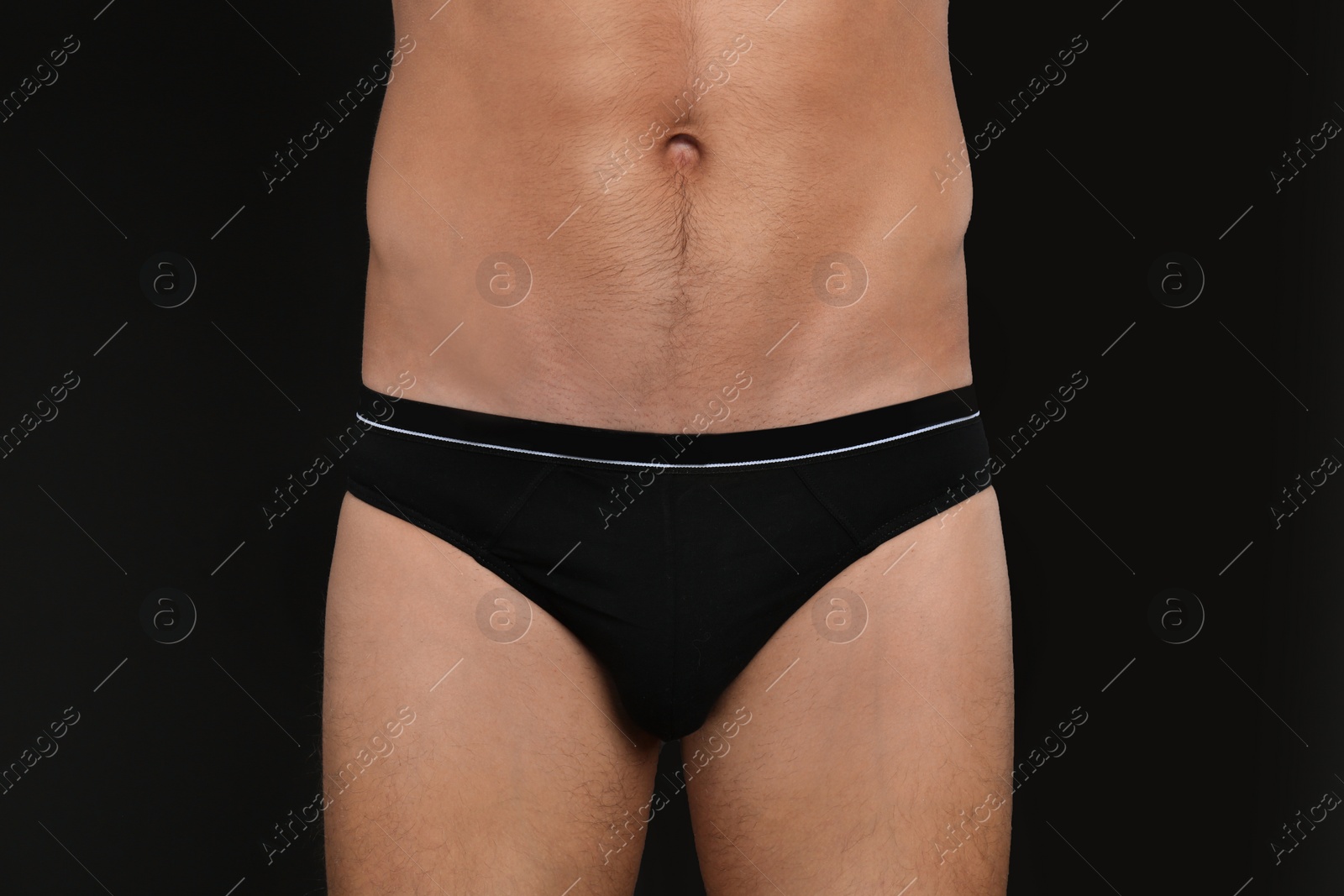 Photo of Man in underwear on black background, closeup