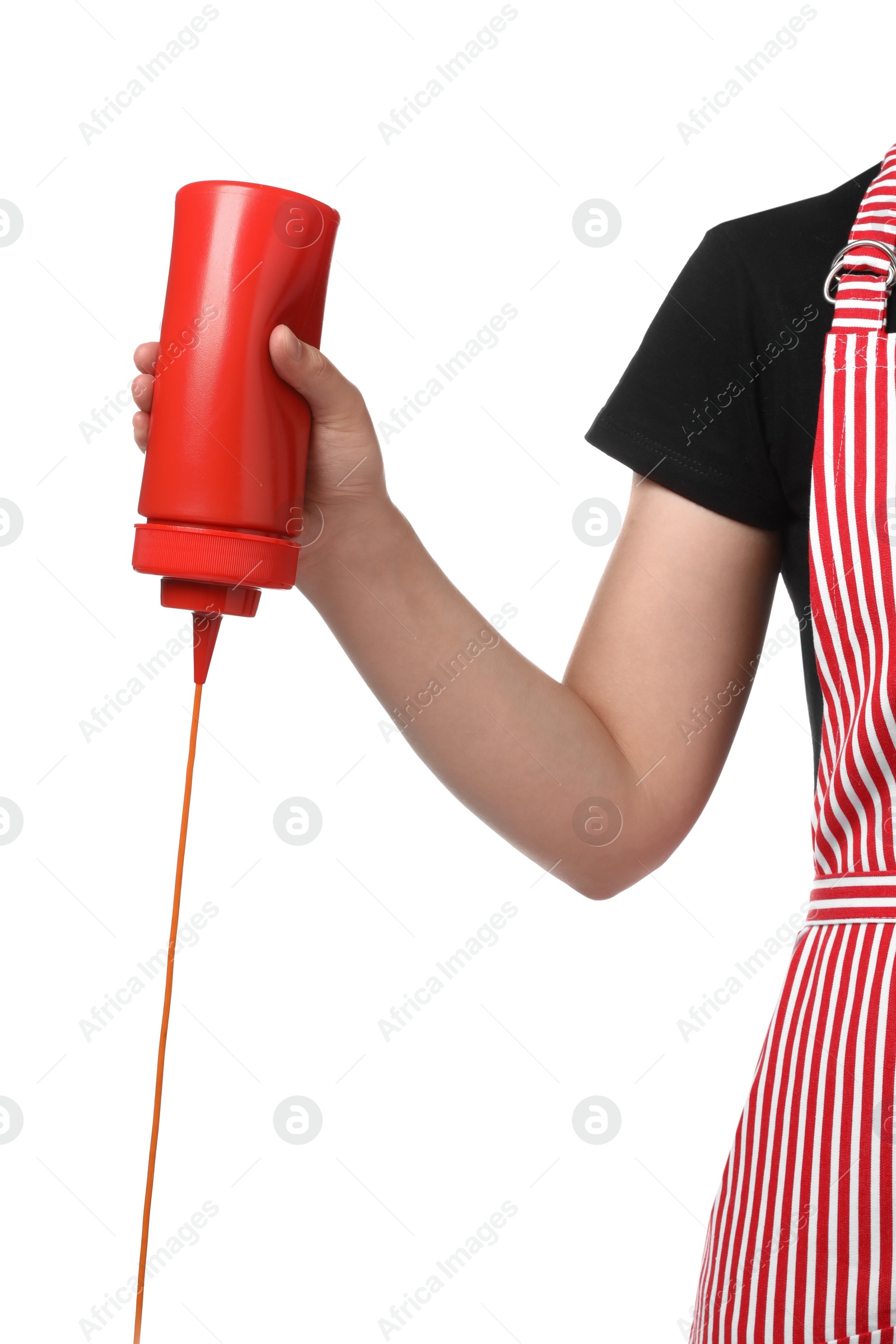 Photo of Woman pouring tasty ketchup from bottle on white background, closeup