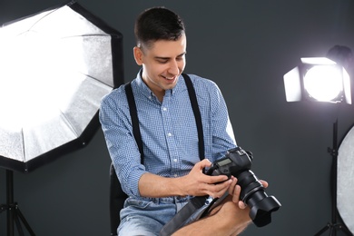 Young photographer working in professional studio