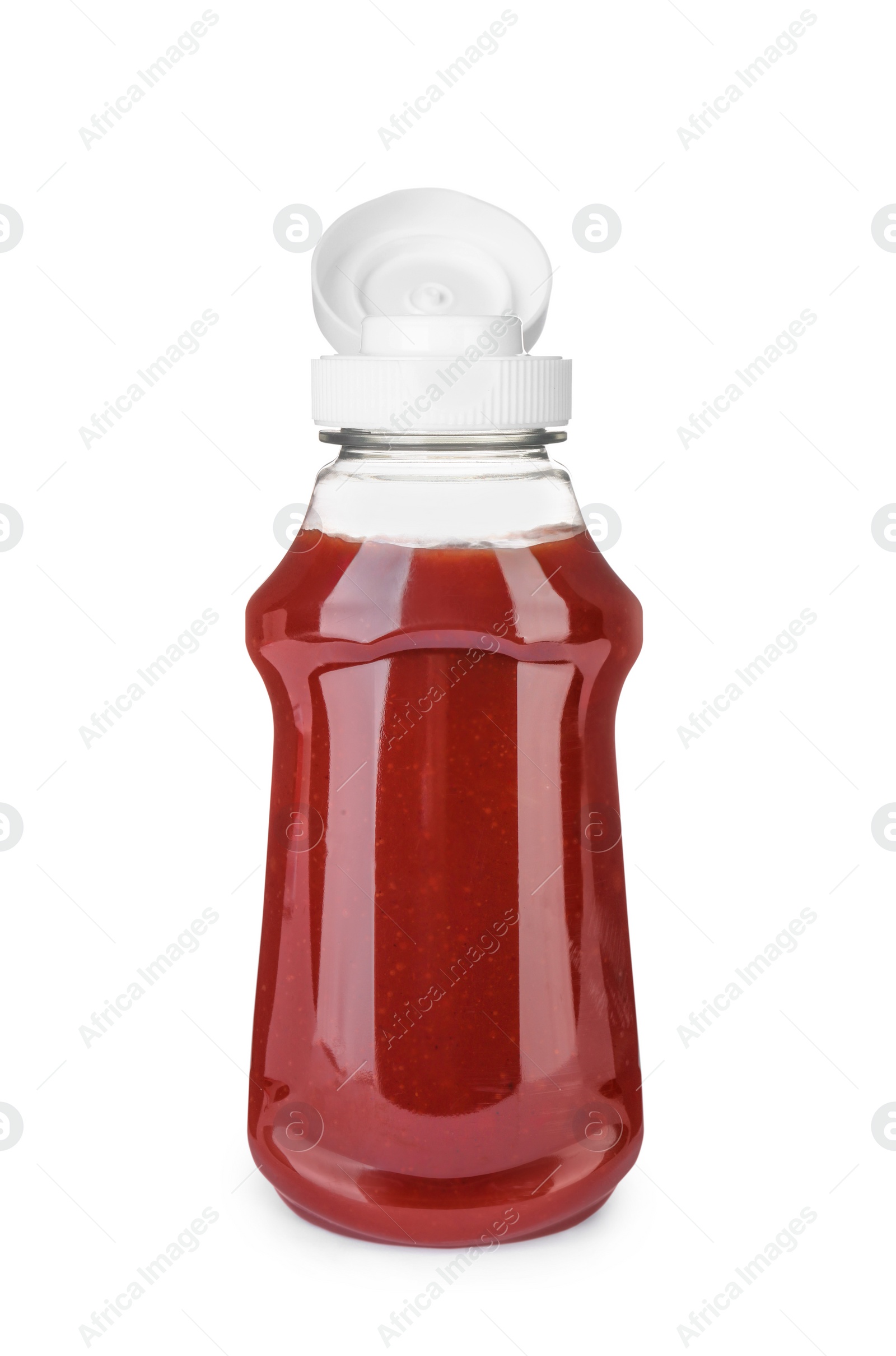 Photo of Bottle of tasty ketchup isolated on white