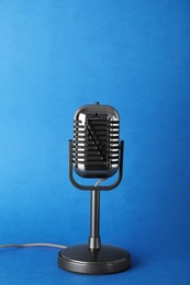 Photo of Retro old style microphone on color background