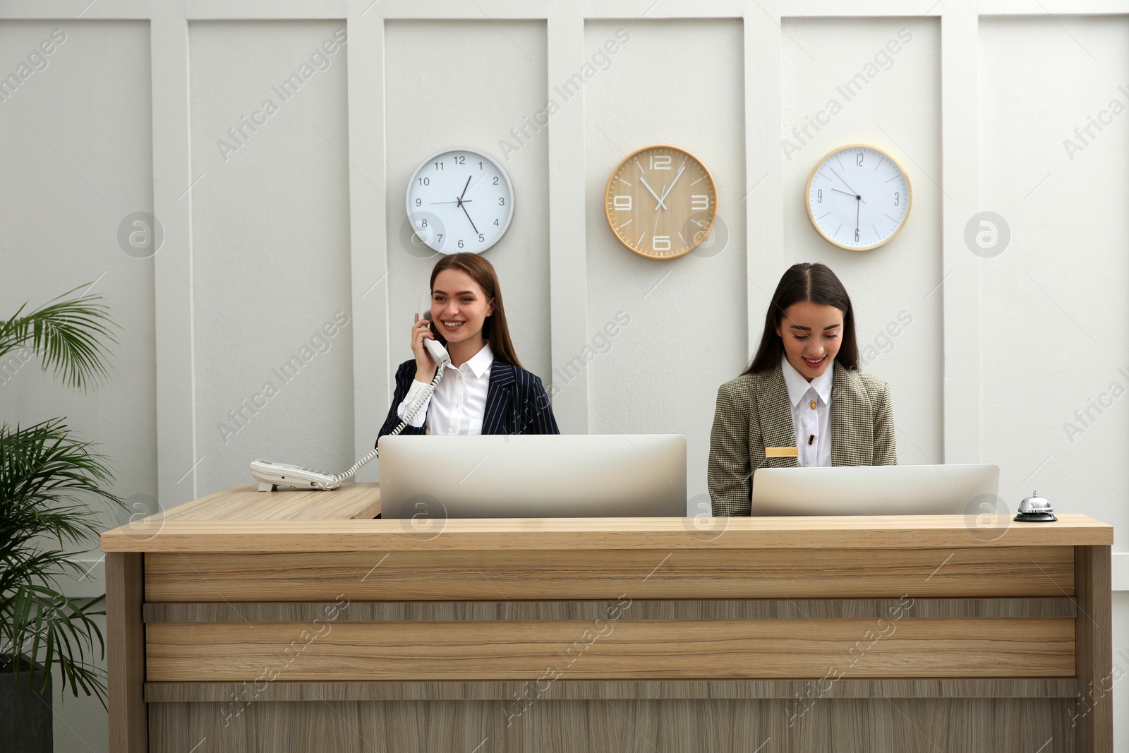 Photo of Beautiful receptionists working at counter in hotel