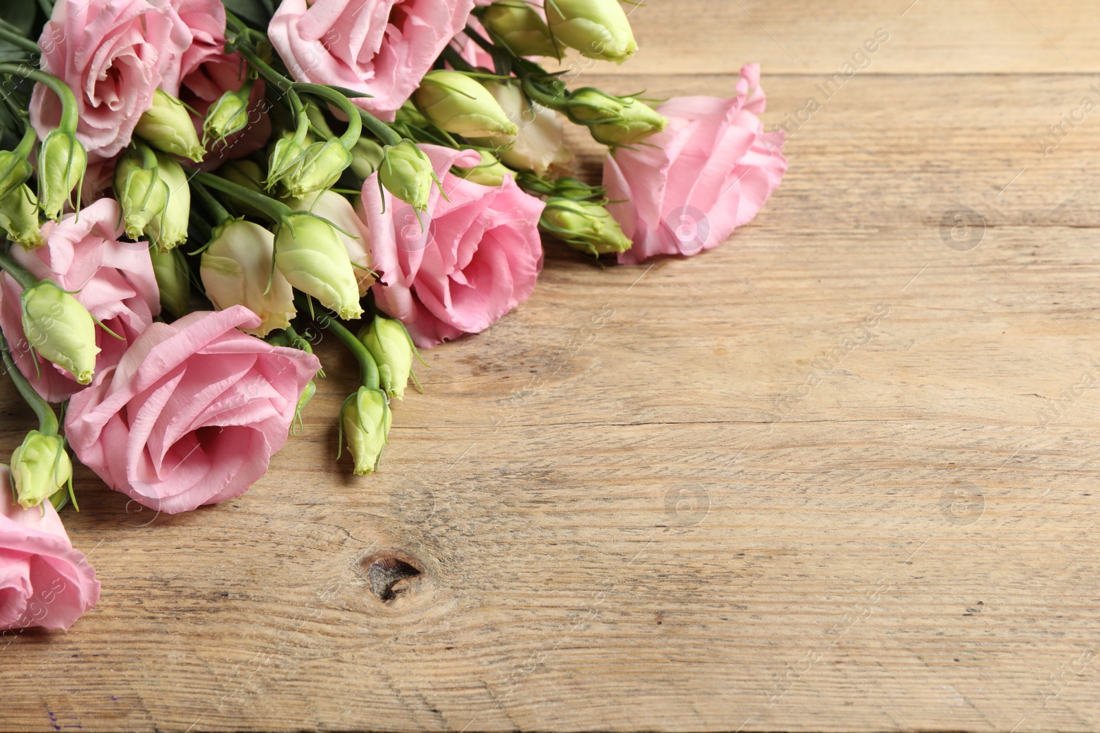 Photo of Happy Mother's Day. Beautiful flowers on wooden table, space for text