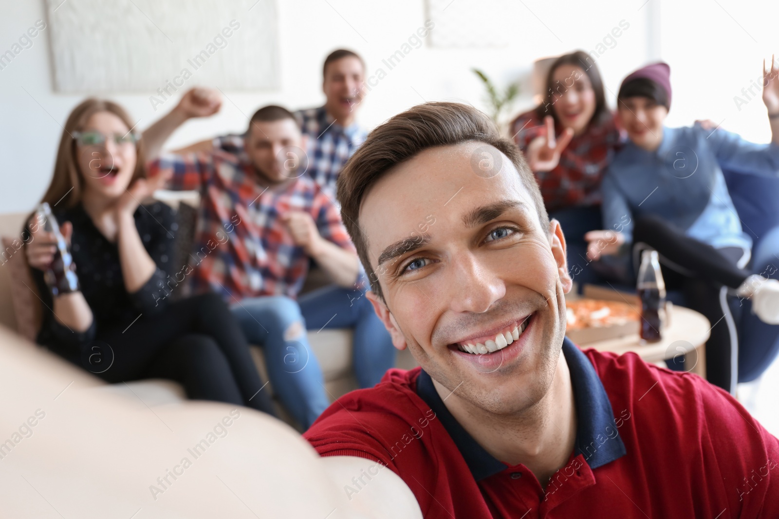 Photo of Happy friends taking selfie indoors