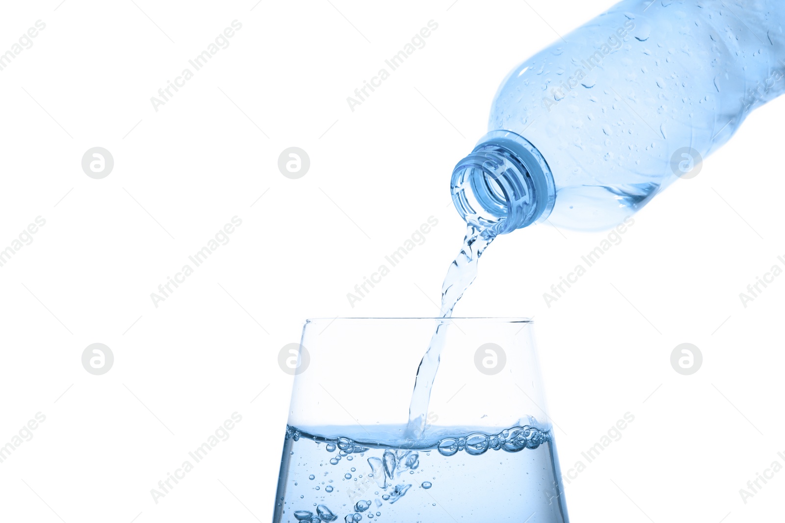 Photo of Pouring water from bottle into glass against blue background. Refreshing drink
