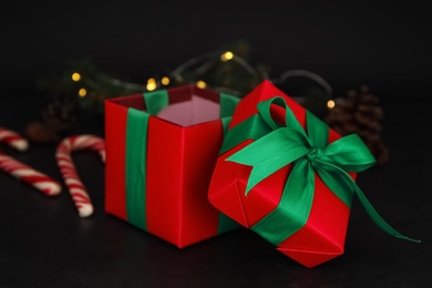 Photo of Red Christmas gift box with green bow on black table