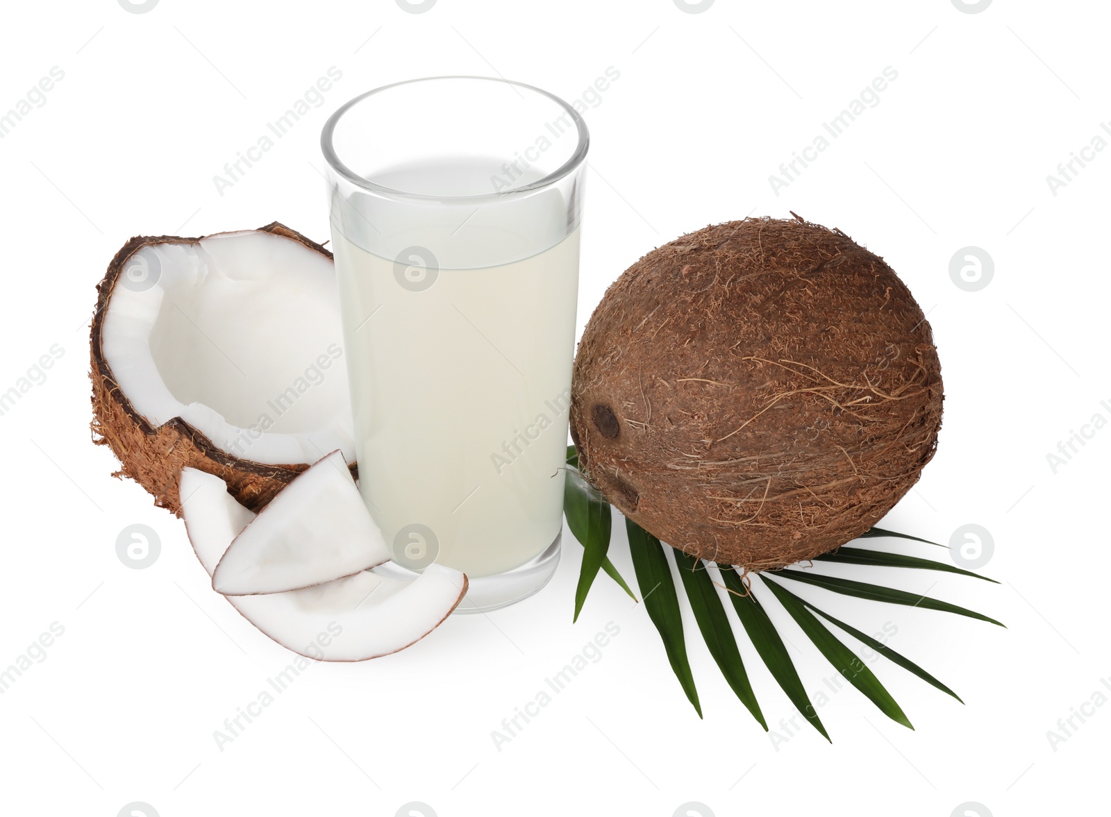 Photo of Glass of coconut water, leaf and nuts isolated on white