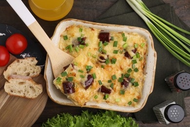 Photo of Tasty sausage casserole served on table, flat lay