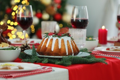 Photo of Festive dinner with delicious cake served on table indoors. Christmas Eve celebration